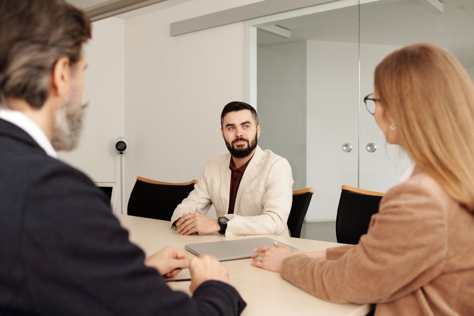California Wrongful Termination 3 Professional business meeting with diverse team members in an office setting.